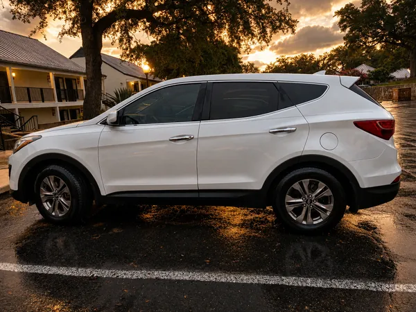 The white Hyundai SUV from the side