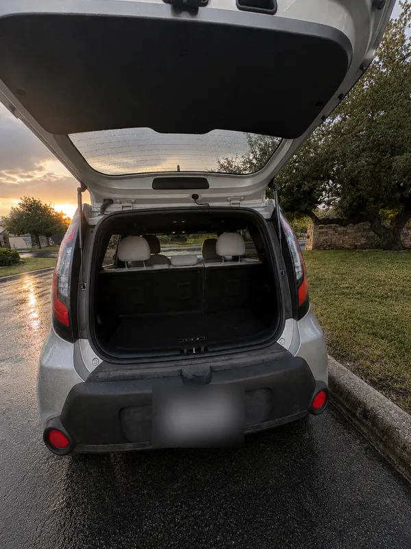 Freedom Rentals’ silver Kia with its hatch open and the cargo space empty