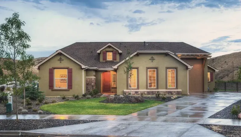 Single-storey house with lit windows at dusk